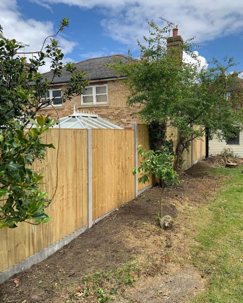 This is a photo of fence panels installed in a residential garden using concrete posts and gravel boards. Installed by Fast Fix Fencing Wisbech